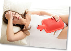 Woman with a hot water bottle on her stomach